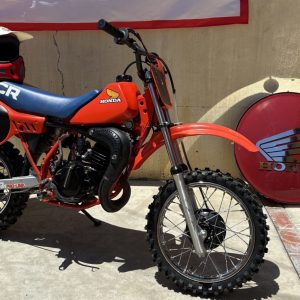 No Reserve: 1983 Honda CR60R, Honda Sign, and Moto4 Helmet